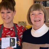 Jane Dalziel of Aromas Cafe in Bean Row, Fallkirk, hands over first Golden Ticket prize to regular customer Janice Johnson