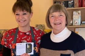 Jane Dalziel of Aromas Cafe in Bean Row, Fallkirk, hands over first Golden Ticket prize to regular customer Janice Johnson