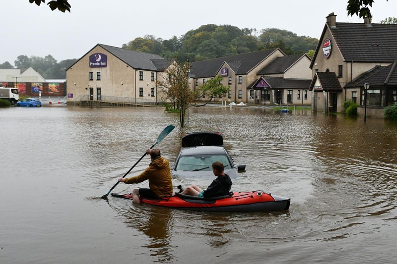 Flooding at The Cadgers Brae Brewers Fayre in Polmont left several people stranded and cars submerged.