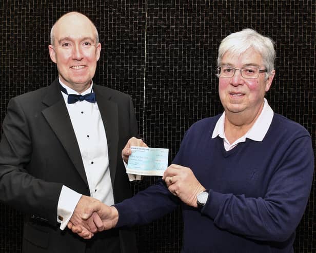 David Wheeler, chairman and president, of Falkirk Burns club, presents a cheque for £500 to Alastair Blackstock, chairman Falkirk Foodbank. Pic: Michael Gillen