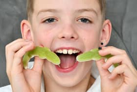 Nine-year-old Aaron Clark, aka The Kandy Kid, samples some of his wares. Pic: Michael Gillen