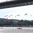 An international team of Greenpeace activists abseil from Scotland's Forth Bridge to block an Ineos tanker from delivering its cargo of fracked American gas to the Grangemouth petrochemical facility. 