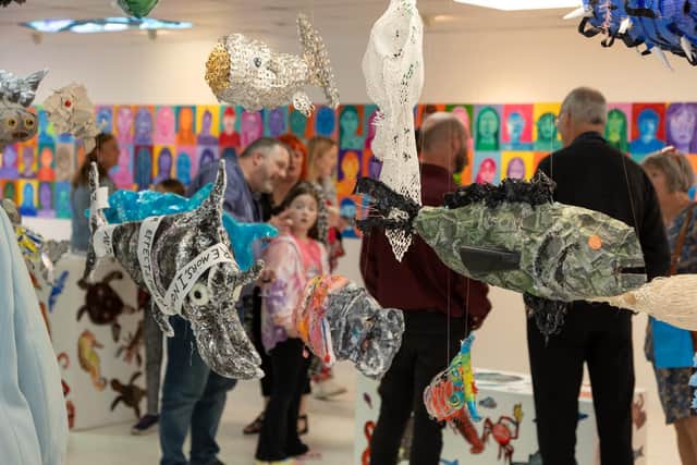 Visitors taking in the fishy mobiles. Pic; Joanne Boyle