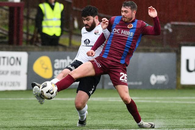Stenny's Bobby McLuckie gets stuck into Andrew Steeves of Montrose