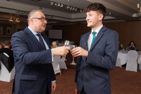 Brett Ingle, Macdonald Inchyra general manager, with Hospitality Academy graduate Jack Masters, toasting ten years of the initiatiave. Pic: Contributed.