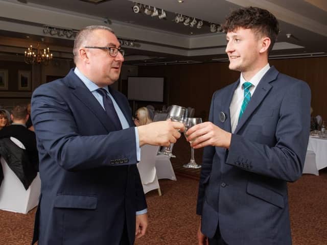 Brett Ingle, Macdonald Inchyra general manager, with Hospitality Academy graduate Jack Masters, toasting ten years of the initiatiave. Pic: Contributed.