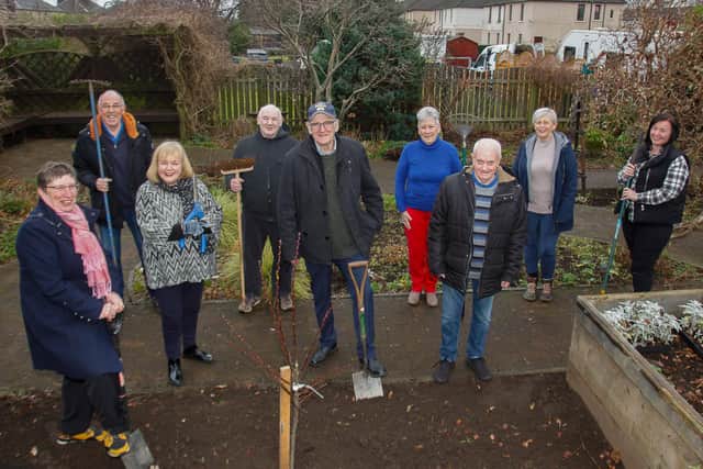 President Fiona Richardson and Past President Alison Finlay of Soroptimists International Falkirk with the members of Alzheimer's Scotland Gardening Club on the occasion of Soroptimists  International donating a tree  at their facility in Stenhousemuir to mark the centenary of SI.
