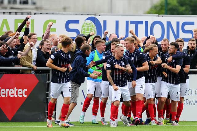 The Falkirk players celebrate Aidan Nesbitt's goal with the travelling away supporters inside the Balmoral Stadium