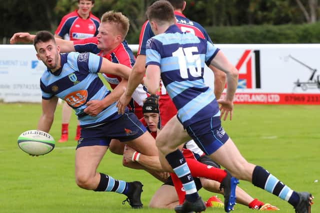 Connor Faulds aims his pass to a team-mate under pressure (Pics by Gordon Honeyman)