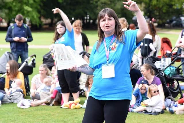Librarian Debbie Scott bringing books to life at an outside Bookbug event