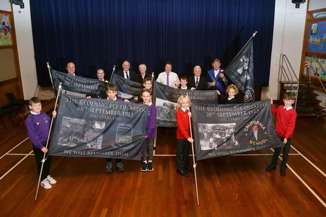 Schools receiving flags for the Redding pit disaster new memorial stone dedication on Saturday. Pictured: Provost Robert Bissett, Pat Reid, Ian Scott, Billy Buchanan, Free Colliers and pupils from Wallacestone Primary, California Primary and Shieldhill Primary. Pic: Michael Gillen