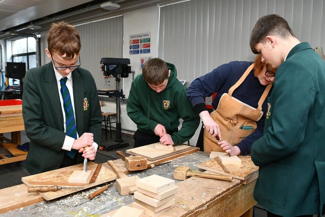 Trying out woodcarving for themselves.