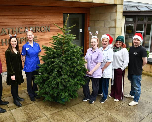 Strathcarron Hospice will be joined by Torwood Garden Centre and Sustainable Thinking Scotland CIC to run a Christmas tree collection fundraiser. Pictured with staff from Strathcarron are Jamie Stevenson, Torwood Garden Centre and Sean Kerr, Sustainable Thinking Scotland CIC Bo'ness. Pic: Michael Gillen