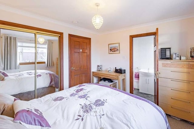The master bedroom boasts built-in cupboards and its own en-suite shower room.