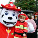 Liam Easson, 2, from Bonnbyridge meets Marshall from PAW Patrol - and they're both wearing their firefighter uniforms.