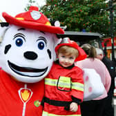 Liam Easson, 2, from Bonnbyridge meets Marshall from PAW Patrol - and they're both wearing their firefighter uniforms.