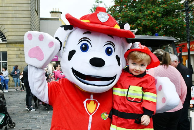 Liam Easson, 2, from Bonnbyridge meets Marshall from PAW Patrol - and they're both wearing their firefighter uniforms.