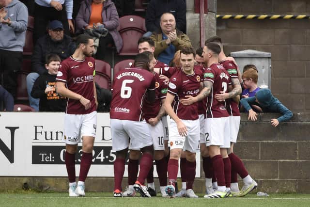 Matty Yates is mobbed after scoring Stenny's second (Photo: Alan Murray)