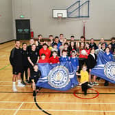 Bo'ness Academy receiving its Sport Scotland Gold School Sport Award.  Academy pupils pictured with some of the cluster primary school pupils, different local sports clubs, Academy PE department teachers and Active Schools Coordinators. Pic: Michael Gillen