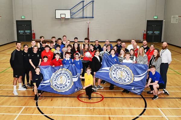 Bo'ness Academy receiving its Sport Scotland Gold School Sport Award.  Academy pupils pictured with some of the cluster primary school pupils, different local sports clubs, Academy PE department teachers and Active Schools Coordinators. Pic: Michael Gillen