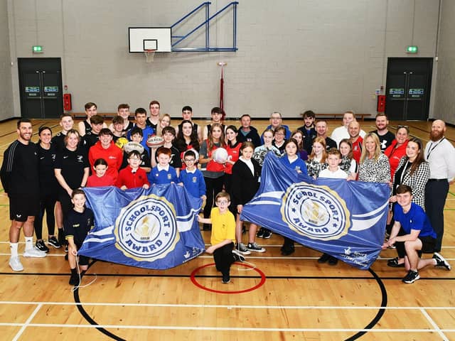 Bo'ness Academy receiving its Sport Scotland Gold School Sport Award.  Academy pupils pictured with some of the cluster primary school pupils, different local sports clubs, Academy PE department teachers and Active Schools Coordinators. Pic: Michael Gillen