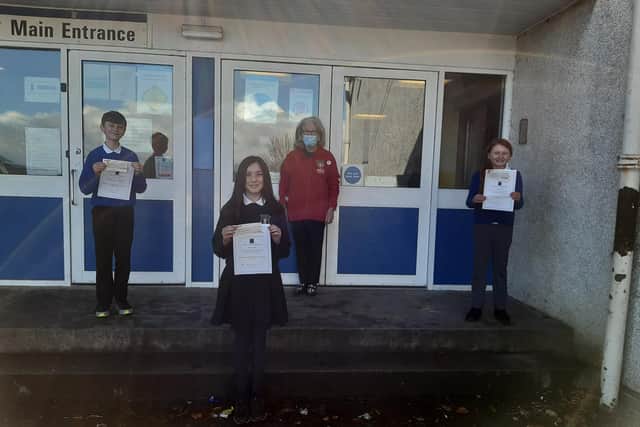 Wallacestone Primary School pupils Alice Ohlstenhius, Holly Curtis and Matthew Savage receive their prizes for this year's Falkirk Rotary Club young writers competition