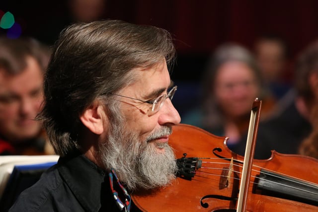 This violinist enjoying the concert as much as the audience.