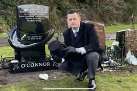 Steven O'Connor at his father's grave with the one-of-a kind headstone in Camelon Cemetery