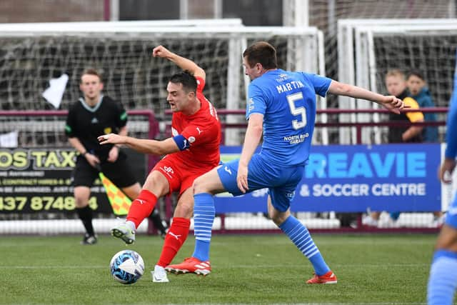 Captain Stephen McGinn crosses into the area past Kelty's Lewis Martin