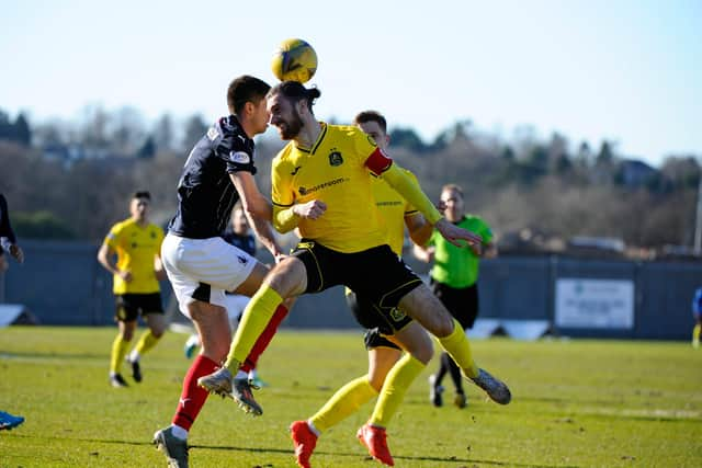 Dumbarton's Gregor Buchanan goes in for a header