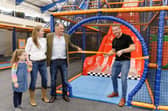 Sir Chris Hoy MBE cutting the ribbon, joined by Conifox managing director James Gammell and part of his family.