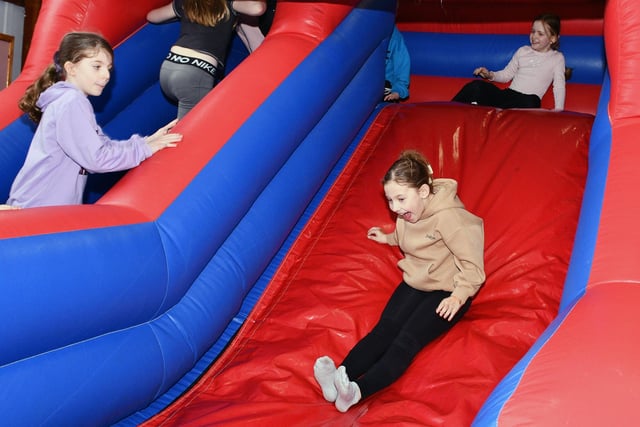 The school hired a bouncy castle and inflatable slide for the children to enjoy as a reward for all their hard work in achieving the accreditation. Pictured: P4 class.
