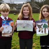 Drumbowie Primary School P5 pupils Brodie Young, Orlagh Lindsay and Rhianne Craig display their winning nature designs