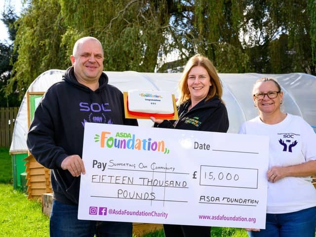 Asda Commmunity Champion Gillian Summers celebrates with Supporting Our Community.