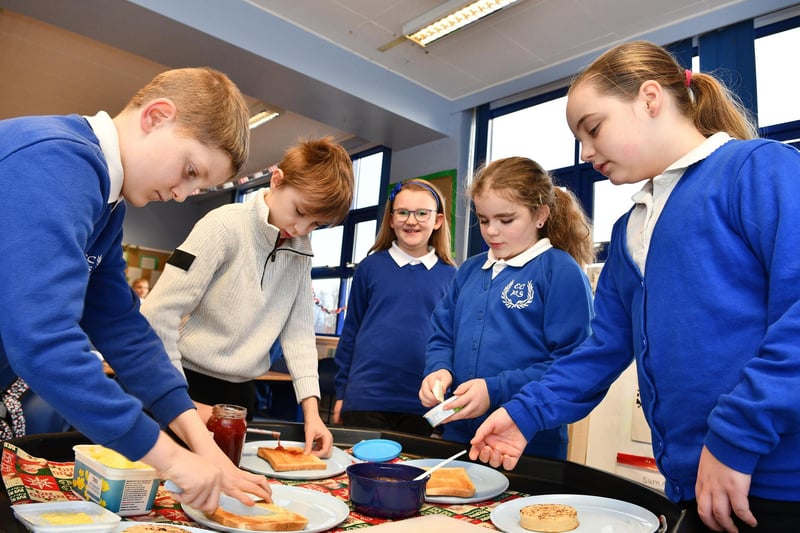 P5 pupils get spreading their choice of toast or crumpets.