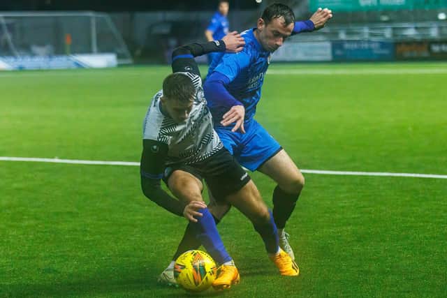 A battle for possession at Falkirk Stadium