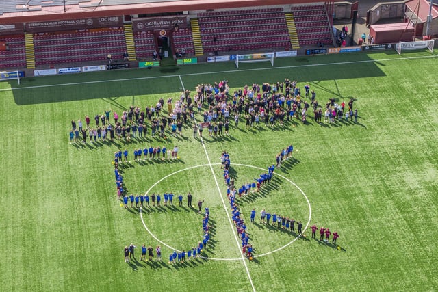 Those taking part in the Warriors Walk pose for a special aerial picture on the Ochilview Park surface
