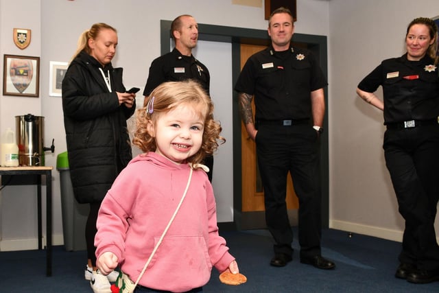 This youngster looks happy with her biscuit.