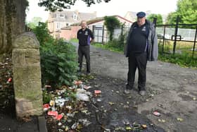 The lane between Pepe's Piri Piri and  St Johns Church just off Glasgow Road, Camelon, has long been a dumping ground for litter and other items and now John Hosie and Dan Rous of community group Our Place Camelon and Tamfourhill are looking for help to deal with the problem