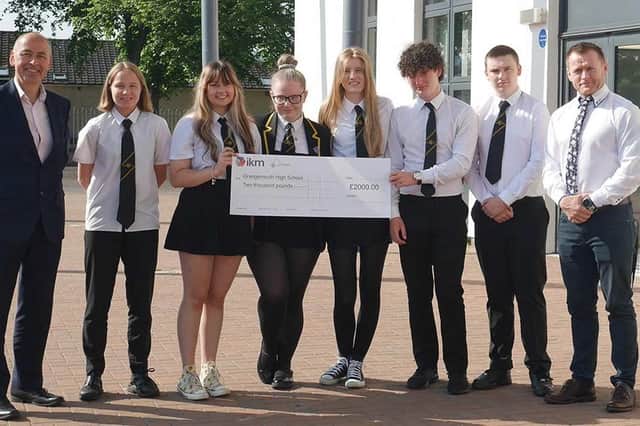 David Taylor, from IKM Consulting hands over the donation to pupils at Grangemouth High School.  (Pic: IKM Consulting)