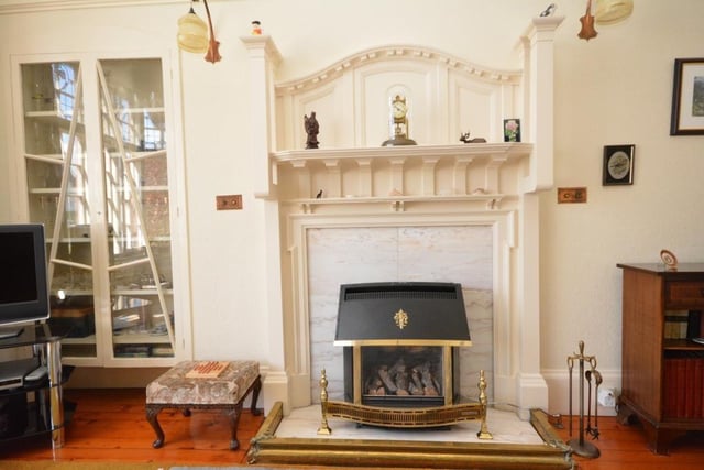 Original timber fire surround and cabinet-work in the sitting room.
