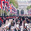 The State Gun Carriage carries the coffin of Queen Elizabeth II, draped in the Royal Standard with the Imperial State Crown and the Sovereign's orb and sceptre, in the Ceremonial Procession following her State Funeral at Westminster Abbey, London. Picture date: Monday September 19, 2022.