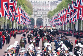 The State Gun Carriage carries the coffin of Queen Elizabeth II, draped in the Royal Standard with the Imperial State Crown and the Sovereign's orb and sceptre, in the Ceremonial Procession following her State Funeral at Westminster Abbey, London. Picture date: Monday September 19, 2022.