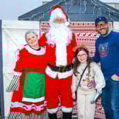 Mrs Claus and Santa Claus with ten-year-old Darcy and her dad Thomas from Larbert.