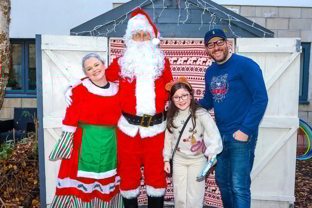 Mrs Claus and Santa Claus with ten-year-old Darcy and her dad Thomas from Larbert.