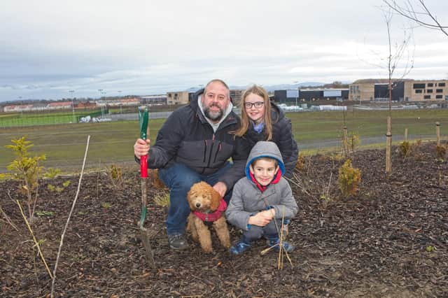 One of the families who turned up to help with planting in the park.