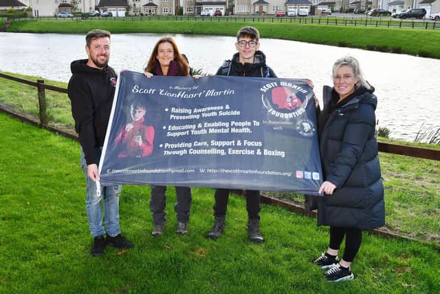 Eleri and Ewan will be taking Scott's banner to the top of the mountain with them on their fundraising challenge.  They are pictured here with Scott's mum Samantha Merrilees and Andrew Merrilees.  (Pic: Michael Gillen)