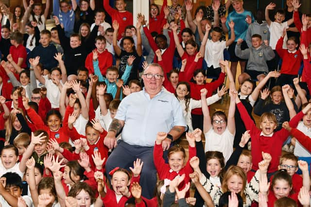 Pupils at Bowhouse Primary School say goodbye to Robert Dick who has been the janitor at the school for 30 years (Picture: Michael Gillen, National World)