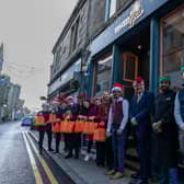 Bo'ness Spice owner Mohammad Abbas (maroon top) and team, local MP Martyn Day and the Dalriada Home Care staff.

Picture: MB Media.