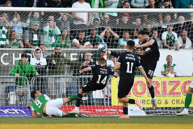 Finn Yeats and Brad McKay combine to clear the ball off the goal line